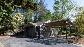 a small gray garage with awning